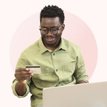 Illustration of young man holding credit card and laptop