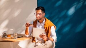 A young man paying online with his credit card