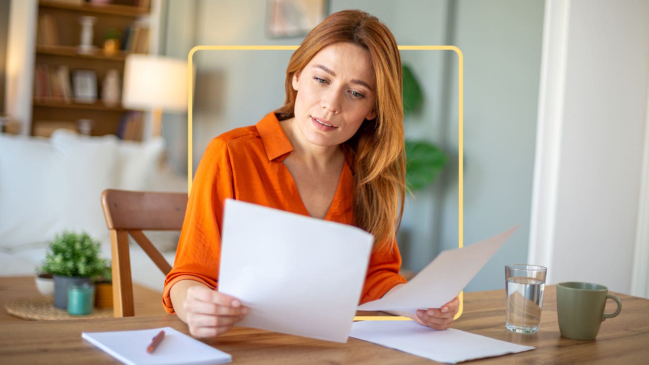 A woman perusing through some papers at her desk