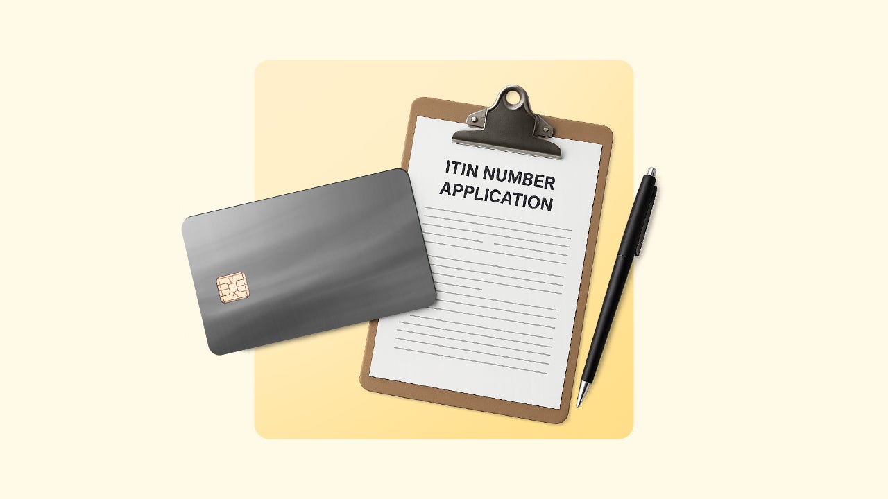 An ITIN number application on a clipboard next to a black pen and black credit card