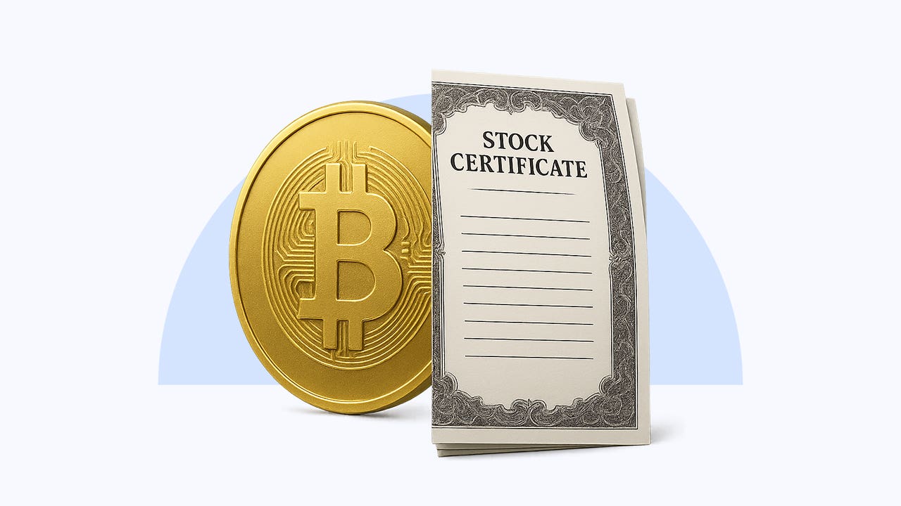 A bitcoin sits next to a stock certificate.
