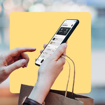 An abstract illustration featuring a set of hands interacting with a shopping portal on a mobile device