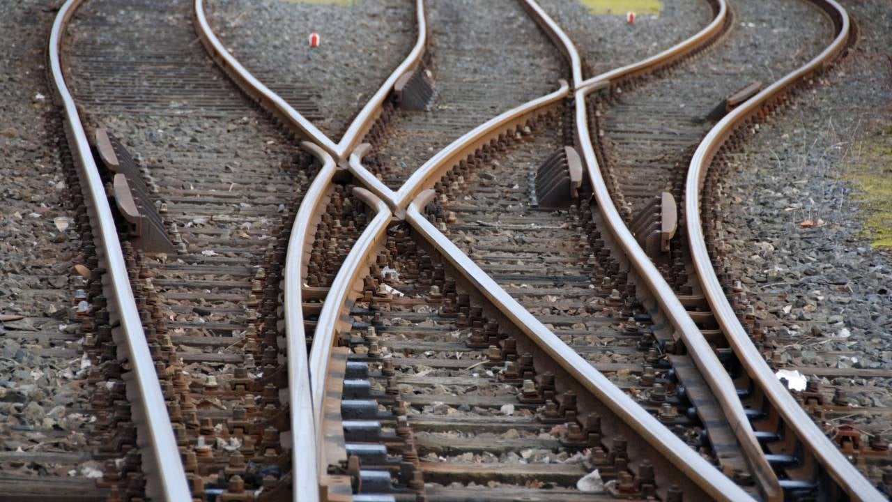 Three train tracks converging.