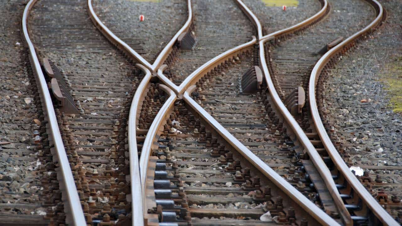 Three train tracks converging.