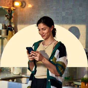 Woman smiling while looking at her phone