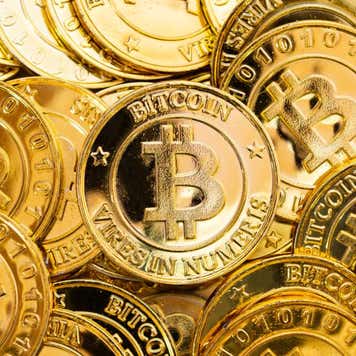 Rendering of multiple golden Bitcoin tokens.