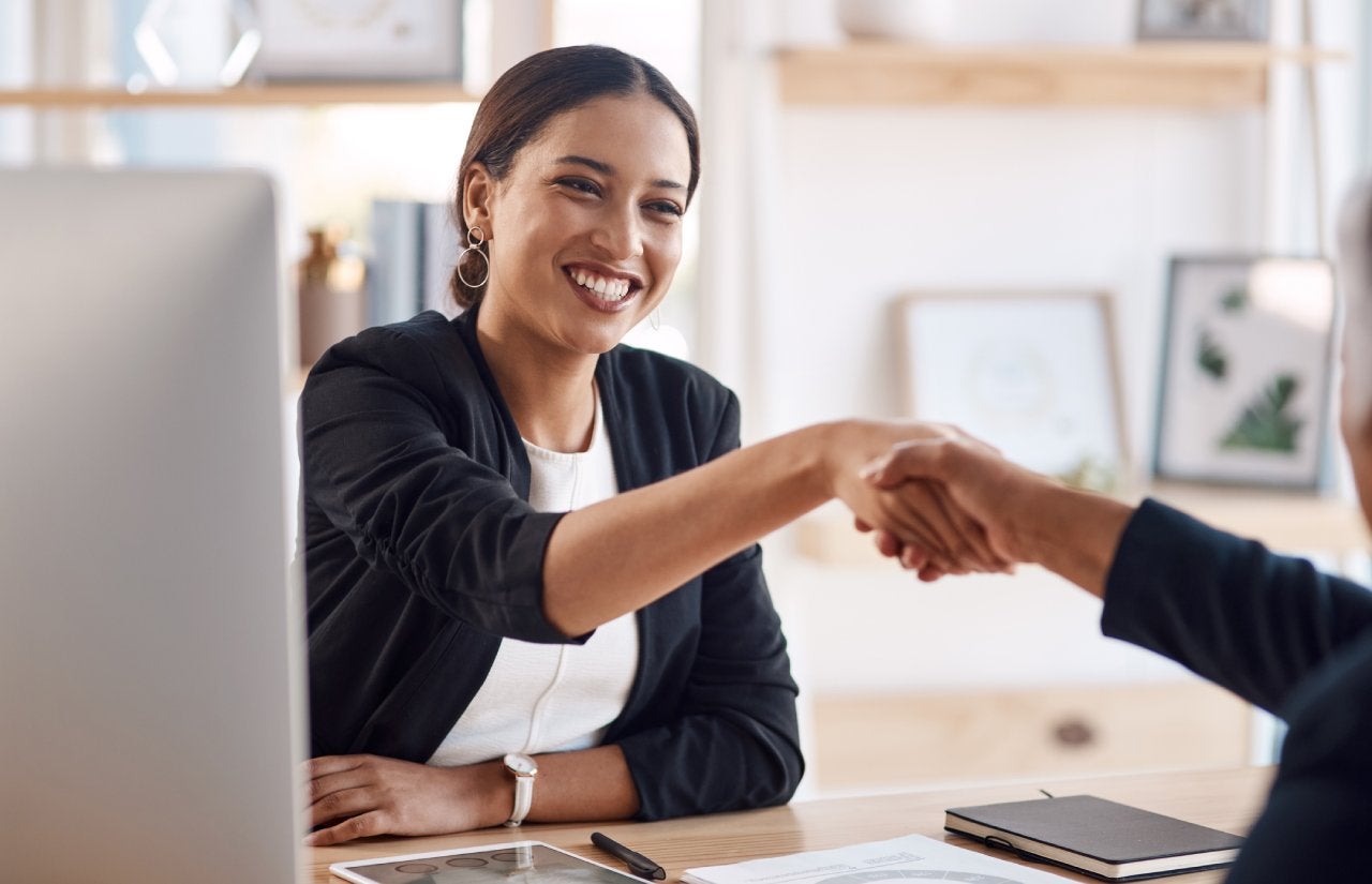 Cropped shot of a young businesswoman shaking hands with a colleague