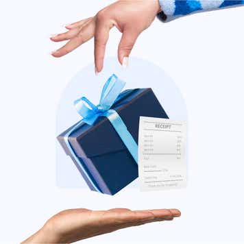 A hand drops a gift and receipt into another hand.