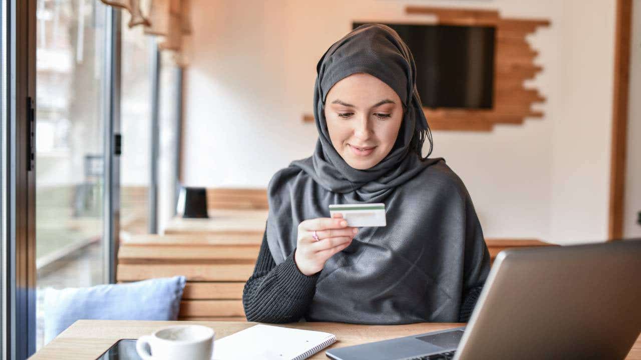 Muslim Female Smiling While Online Shopping