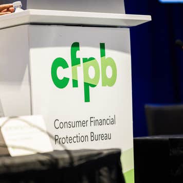 A lectern featuring the logo of the Consumer Financial Protection Bureau