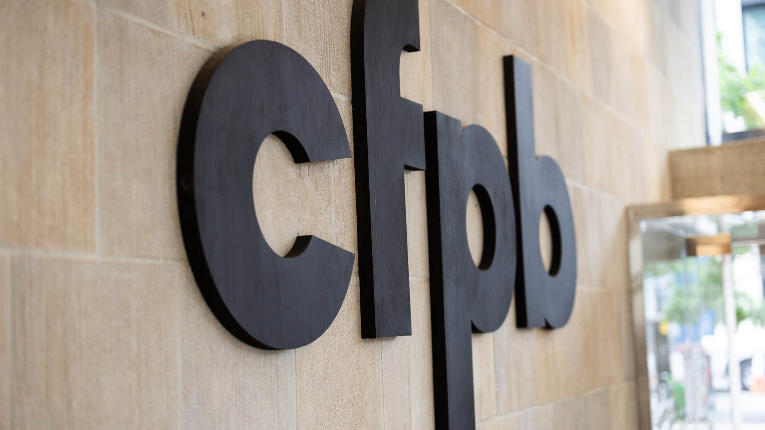 A picture of the side of the Consumer Financial Protection Building, showing the CFPB logo