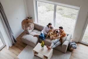 A top view of a young family sitting on a couch in their new home
