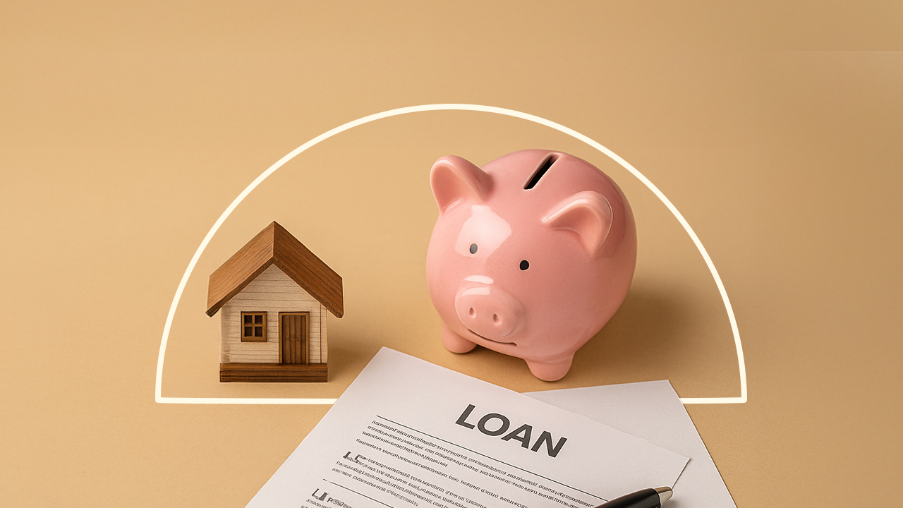 An illustration with a figure of a small house, a piggy bank and a paper with the word "LOAN" written across it.