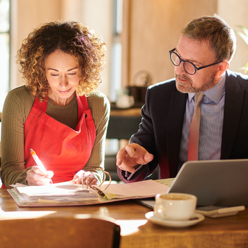 A business owner and a CPA going over tax paperwork.