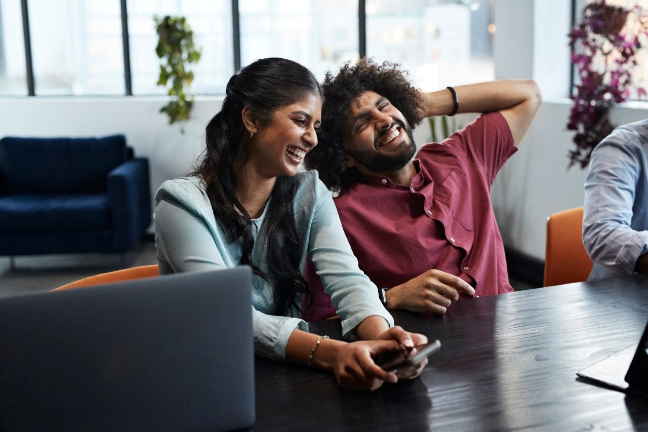Cheerful young business colleagues in office