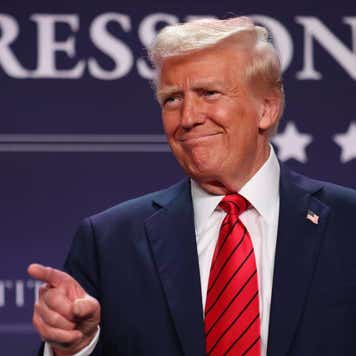 Donald Trump smiling and pointing.