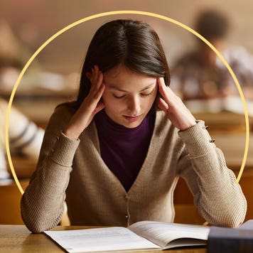 A stressed woman looks at a booklet.