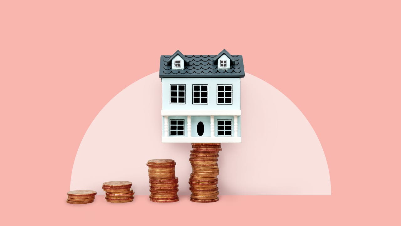 photo illustration - house balanced on stack of coins - pink background