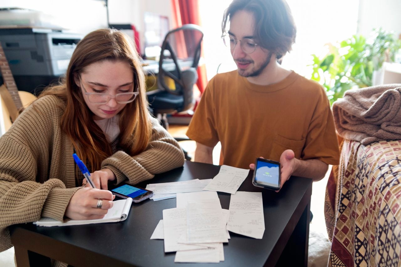 Millennial couple using digital payment to share expense