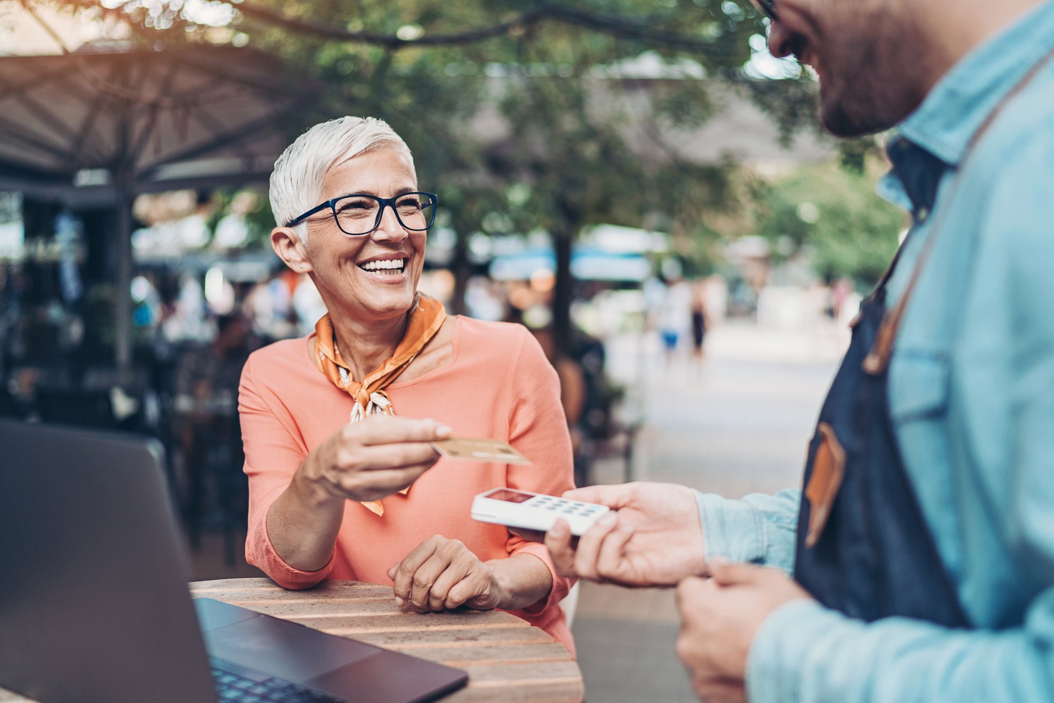 Smiling senior woman making a contactless payment