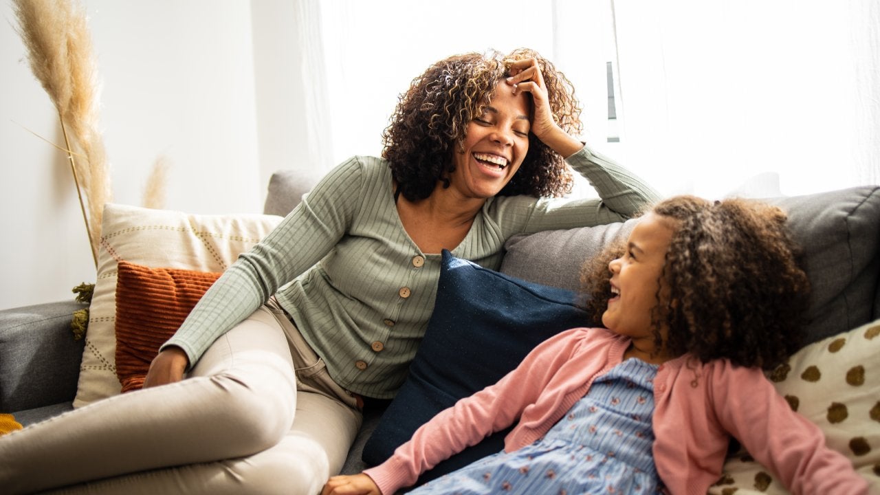 Mother and daughter having fun in the living room