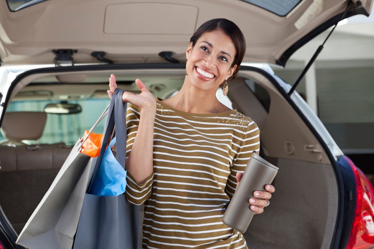 Woman unloading shopping from car