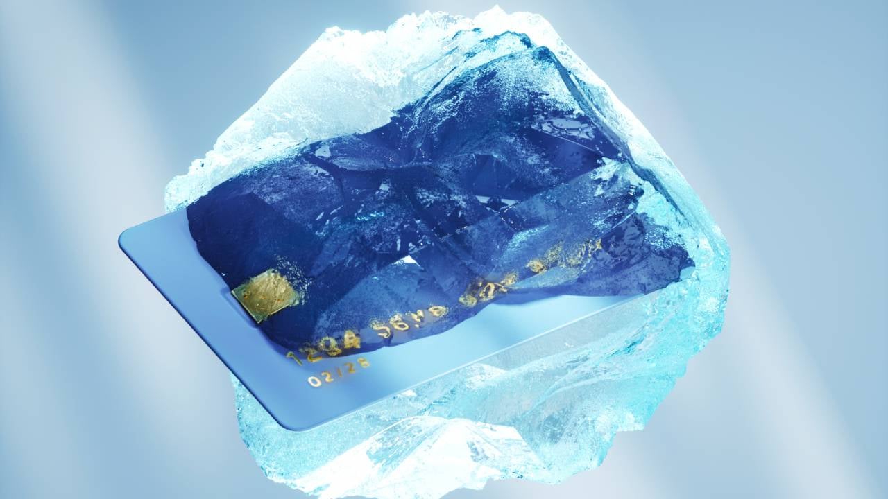 Digital generated image of credit card frozen against light blue background. Financial and banking concept.