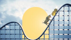 A styalized roller coaster with a bull pushing gold coins up the incline.