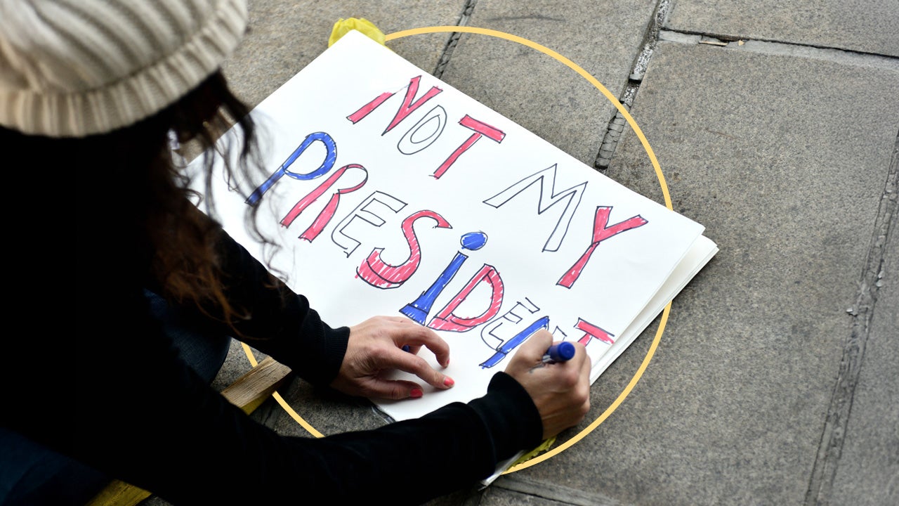 design image of an individual protestor writing out "not my president" on a poster