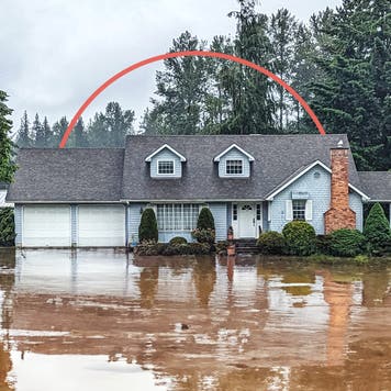 single family home submerged in floodwaters