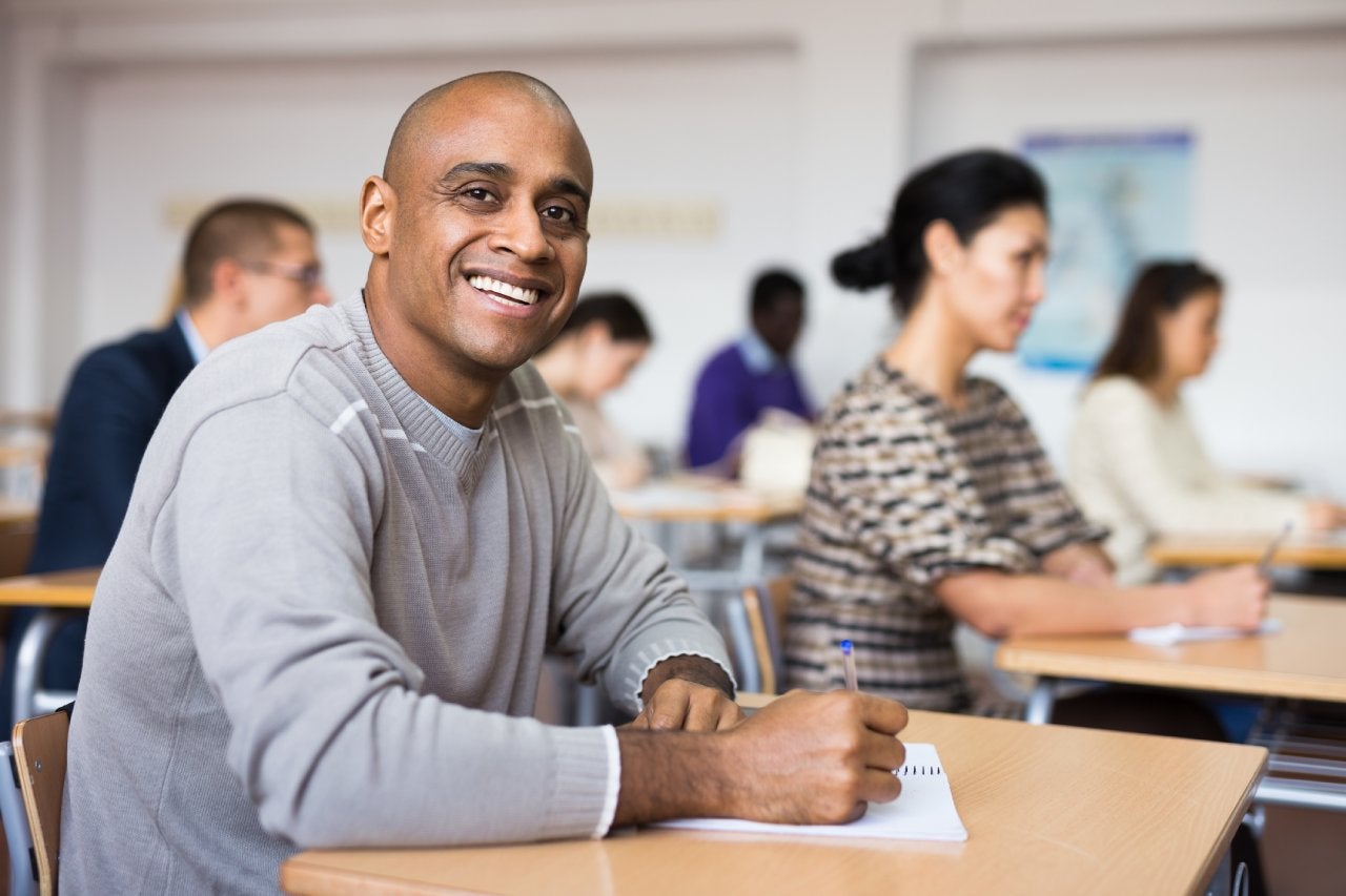 Group of students attentively listening to lecture in classroom