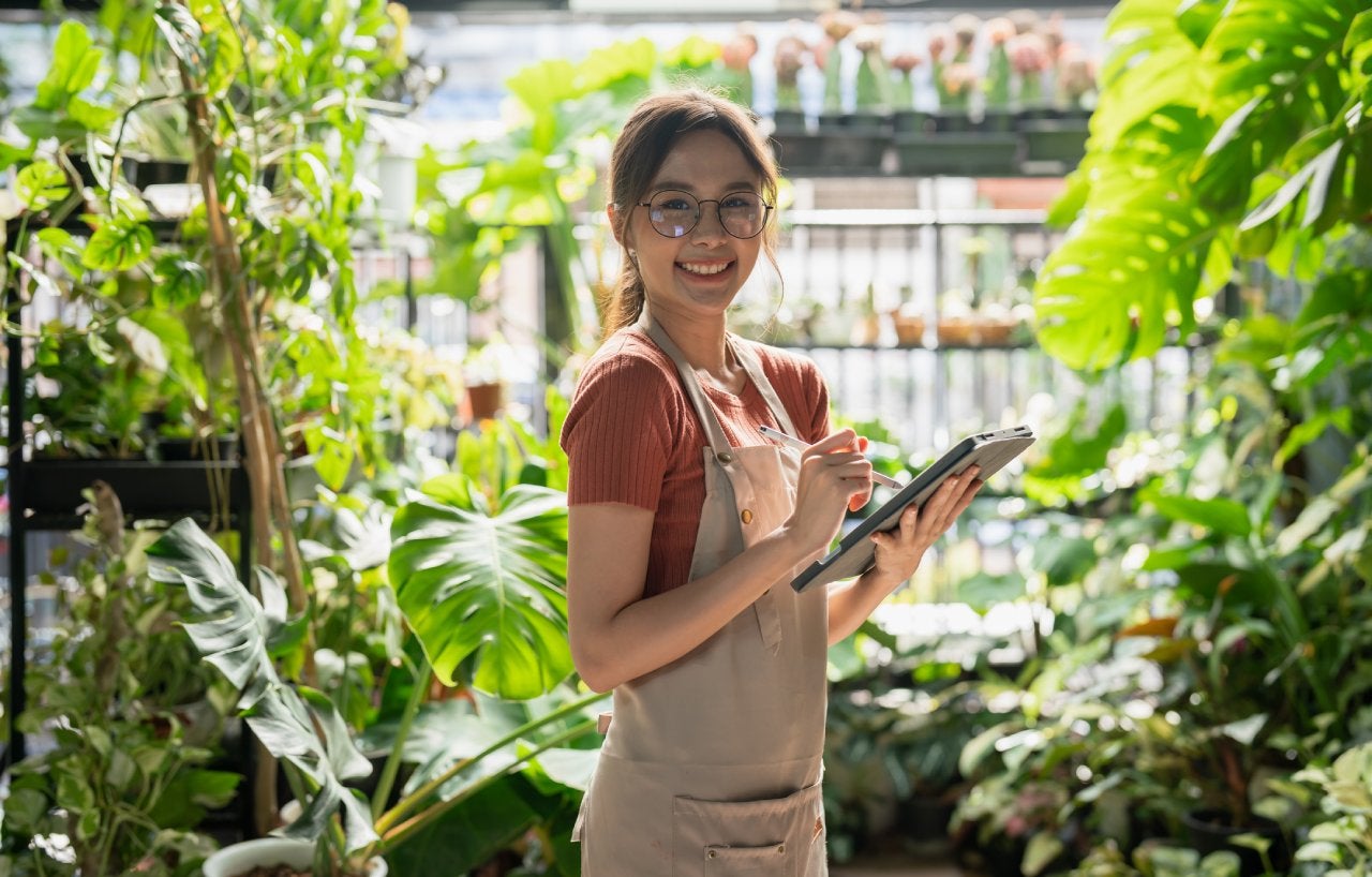 Working women thinking about finance and economy at front garden.woman work in the tablet and working for the financial affairs