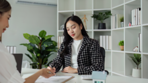 Real estate agent explain sale contract and home insurance to client.