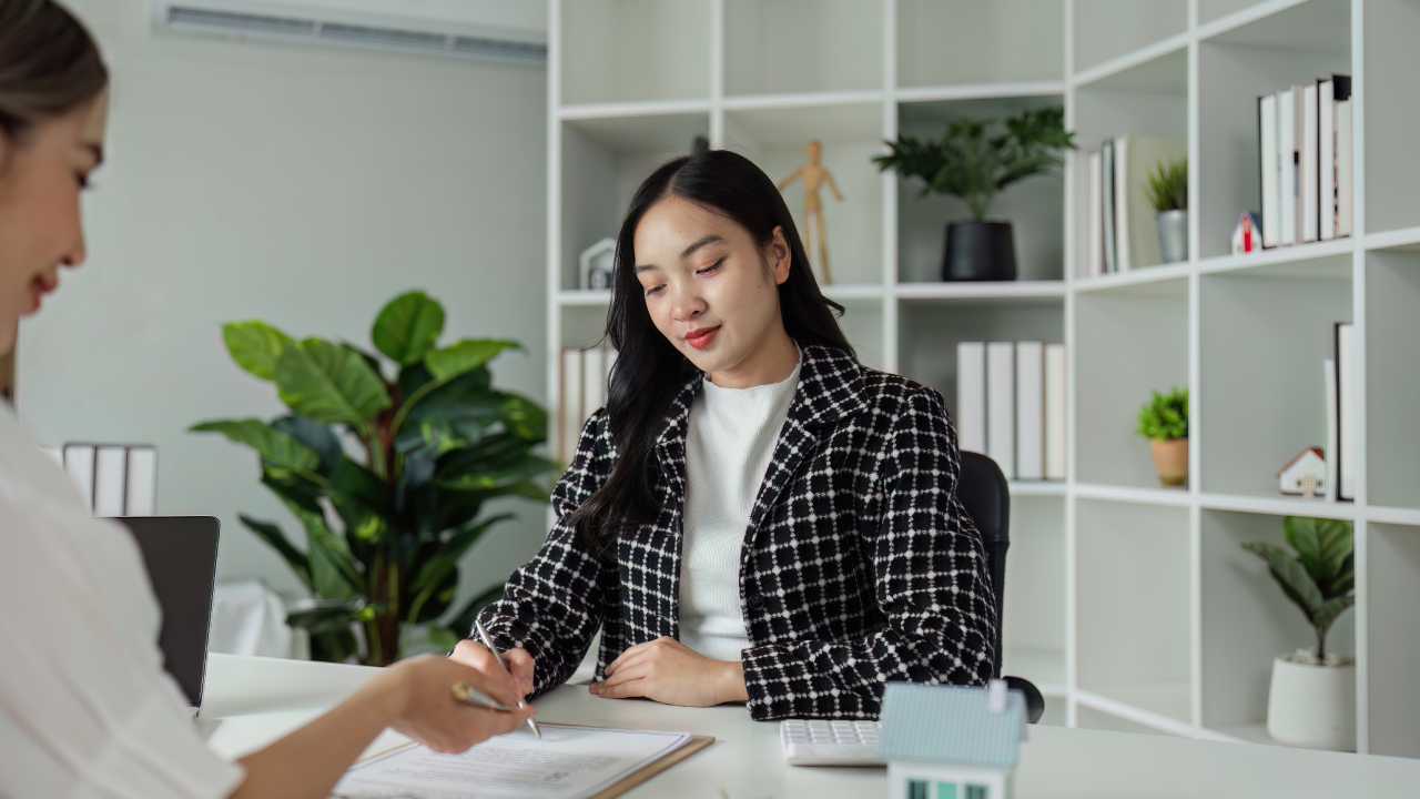 Real estate agent explain sale contract and home insurance to client.