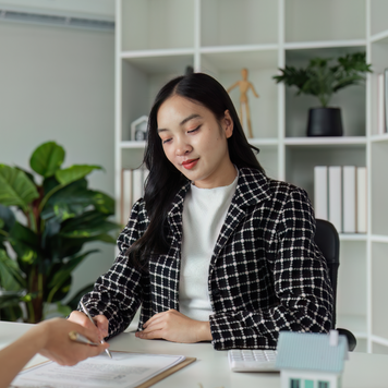 Real estate agent explain sale contract and home insurance to client.