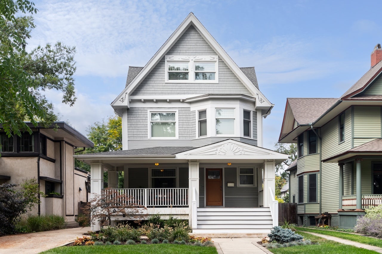A grey and white victorian home exterior.