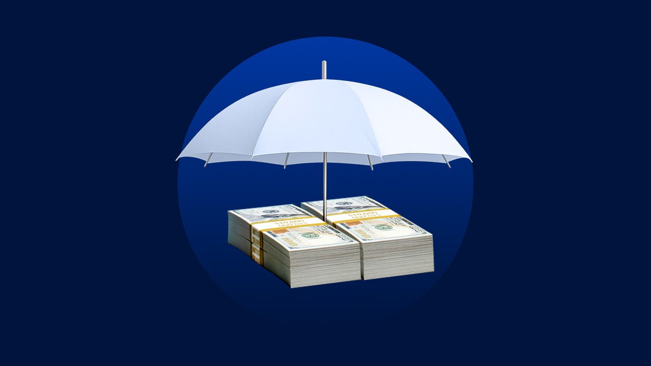 stack of cash being held up by an umbrella