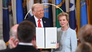 design image of donald trump holding a signed piece of policy