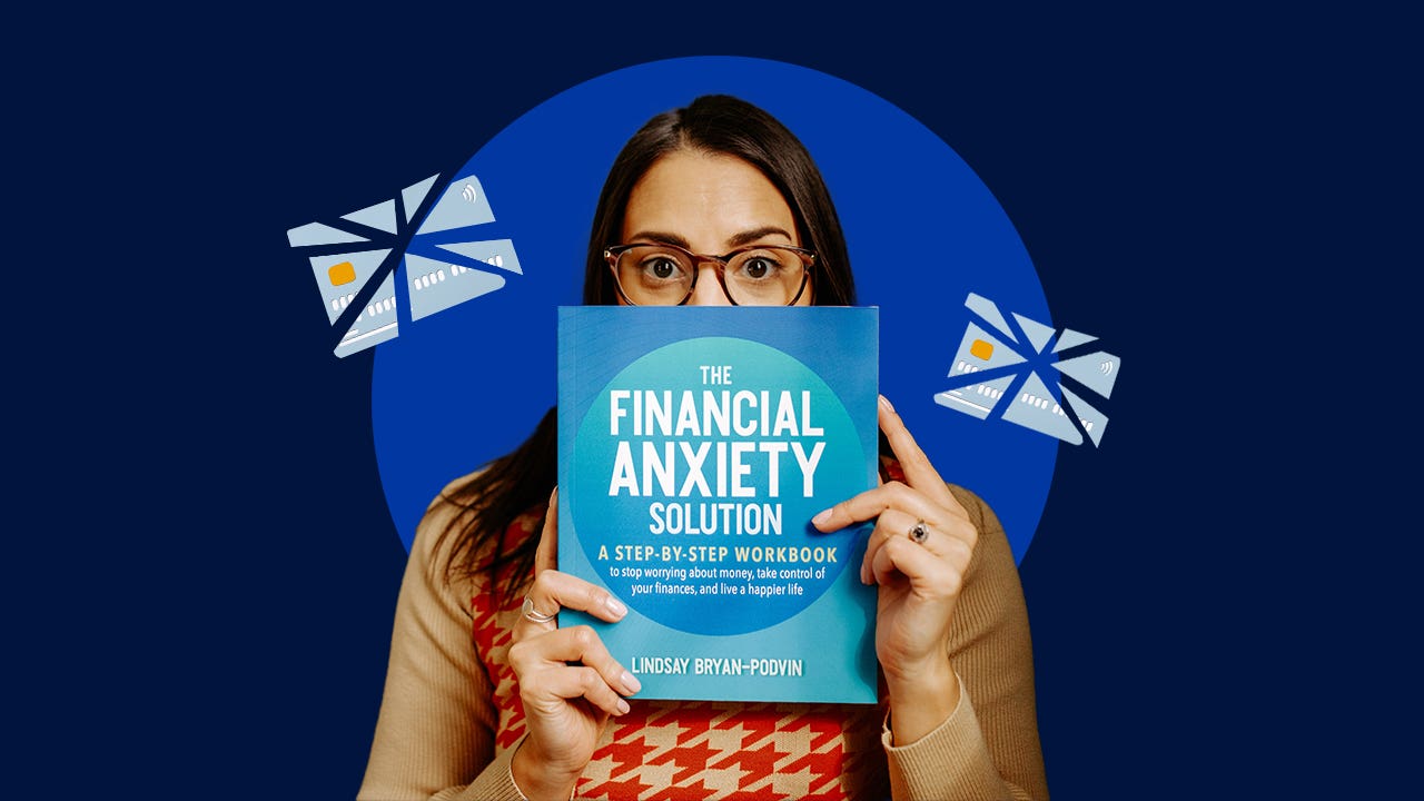 Author Lindsay Bryan-Podvin stands holding a copy of her financial book