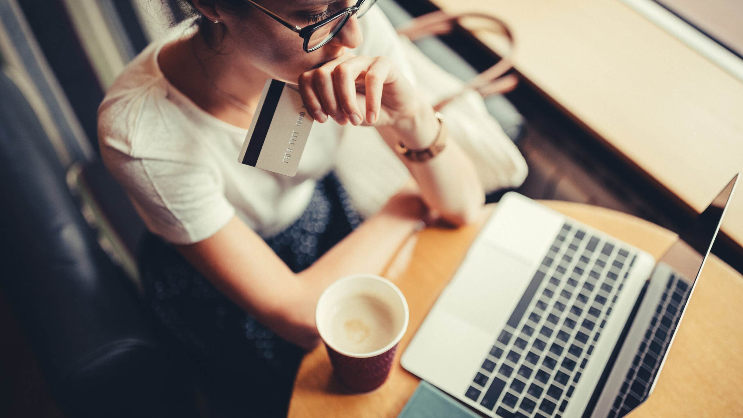 Overhead view of woman who appears worried while looking at a computer
