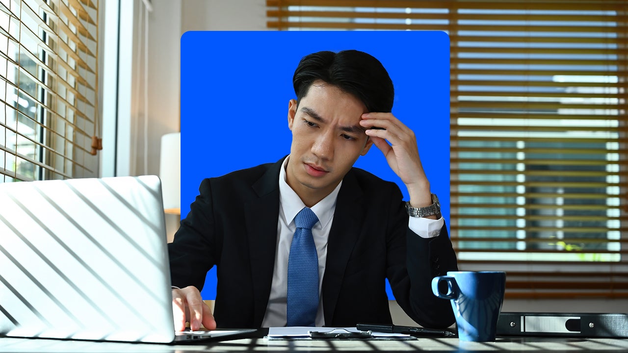 photo illustration of worried man in suit looking at laptop screen