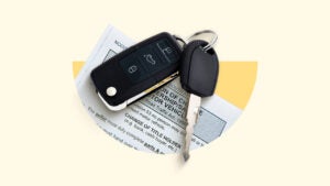 A car key and key fob on top of a sheet of paper.