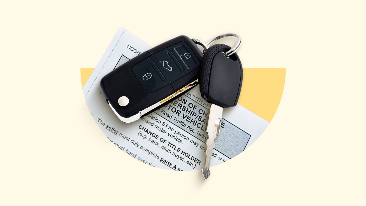 A car key and key fob on top of a sheet of paper.