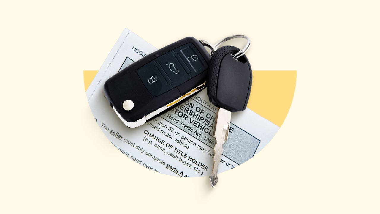 A car key and key fob on top of a sheet of paper.