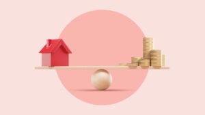 An image of a balance with a red house on one end and a pile of coins on the other on a pink background.