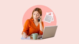 a woman on the phone and her laptop with paper pages in the background