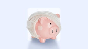 A piggy bank is wrapped in fabric bandages.