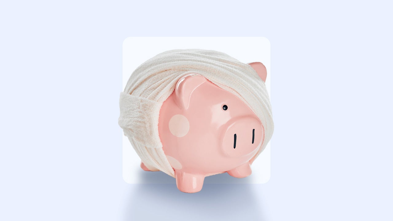 A piggy bank is wrapped in fabric bandages.