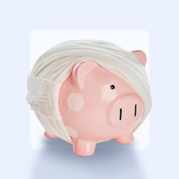 A piggy bank is wrapped in fabric bandages.