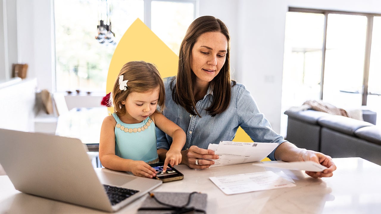 design image of a woman and her daughter at a table, woman reading bills
